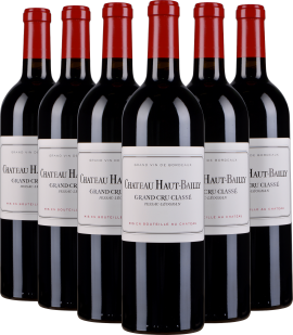 Sechs Bordeaux-Weinflaschen mit rotem Kapselverschluss und weißem Etikett, elegant angeordnet.