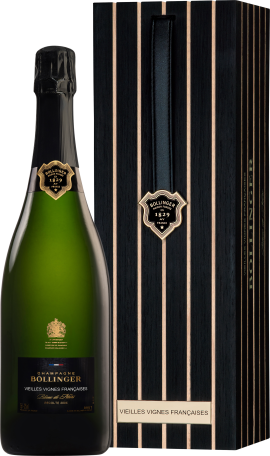 Grüne Champagnerflasche neben eleganter, gestreifter Holzbox.