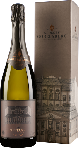 Flasche Sekt mit goldener Flüssigkeit, elegantem Etikett in Braun mit historischem Gebäudemotiv, neben passender Geschenkschachtel mit ähnlichem Design.