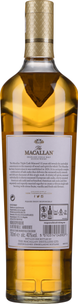 Goldene Flasche mit dekorativem Verschluss und detailliertem Etikett.