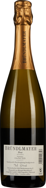 Flasche mit goldener Kapsel, klarer Inhalt, Etikett mit schwarzem Text.