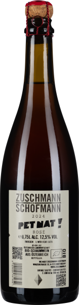 Braune Glasflasche mit Naturkorken und roter Agraffe, schlichtes Etikett.