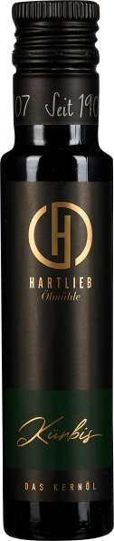 Dunkle Flasche mit goldener Schrift und grünem Etikett.