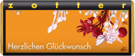 Orange Schokoladenverpackung mit stilisierten roten und weißen Blumenmotiven.