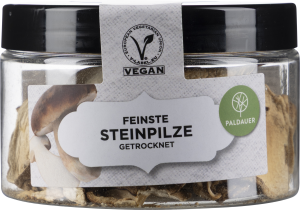 Rundes Glas mit schwarzem Deckel, gefüllt mit getrockneten Pilzen.