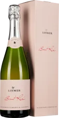 Eine elegante Sektflasche in hellrosa Etikettierung mit silberner Folie am Flaschenhals, neben einer passenden rosa Verpackung.