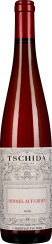 Rote Weinflasche mit dekorativem Etikett und rotem Schraubverschluss.
