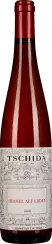 Rote Weinflasche mit dekorativem Etikett und rotem Schraubverschluss.